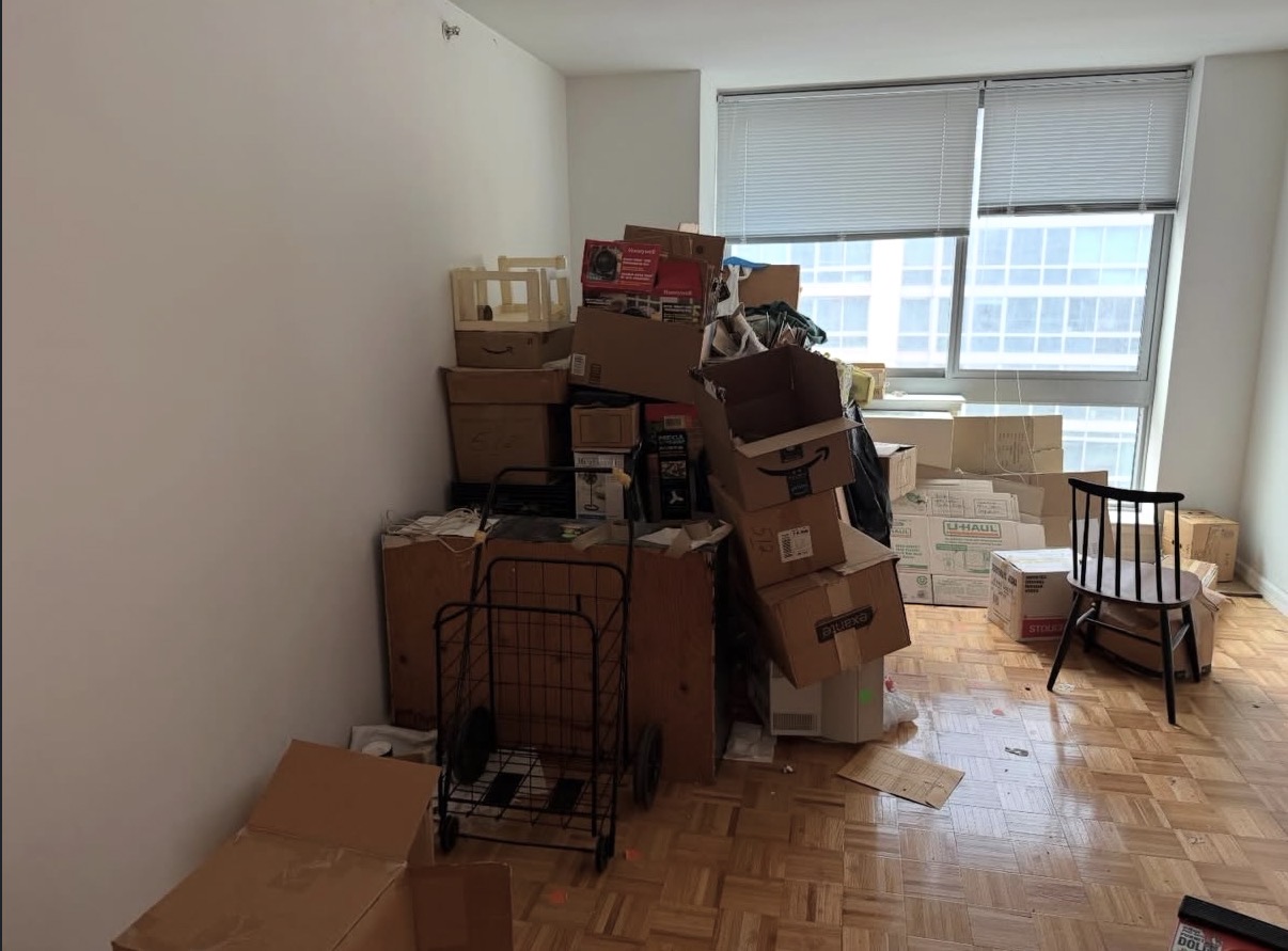 Cluttered room filled with cardboard boxes before junk removal